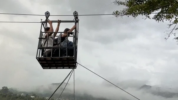 Rescuers use ziplines to transport trapped citizens after devastating Nepal floods decimate country's bridges