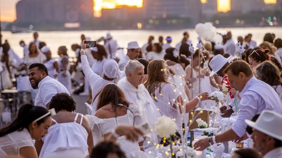 Dinner party has guests bringing tables, dressing in white and learning location at last minute