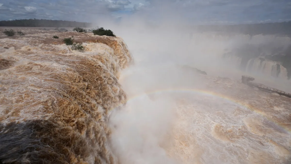 El Niño rains flood South America, sending residents fleeing and cattle swimming