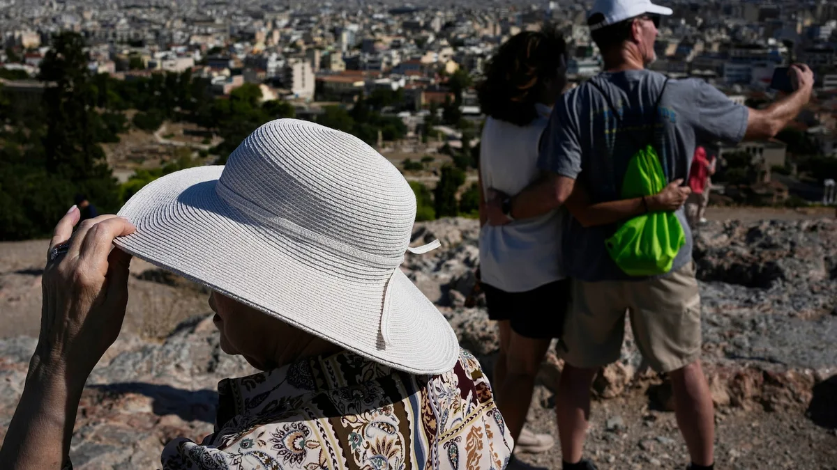 The sunhat is everywhere in Athens as crowds grow larger at ancient sites