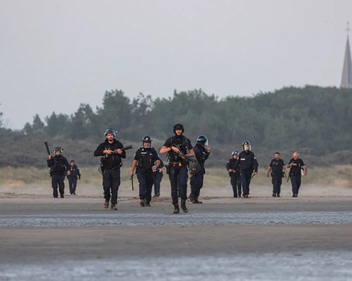 Footage shows French police clashing with people on beach as they try to leave in small boat