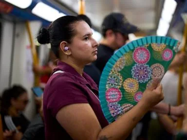In a scorching Spain, the traditional folding hand fan is having a moment