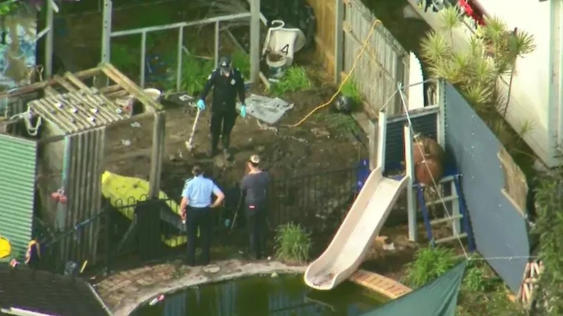 Pair charged with murder after body found buried under cubby house