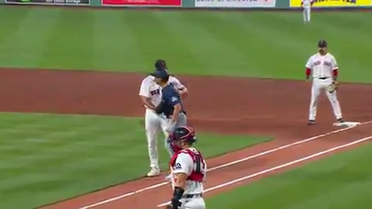 Red Sox’s Tolle hugs Mariners’ Canzone to secure out