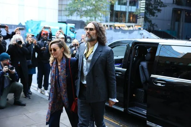 Russell Brand 'grinned like a clown' before 'dragging woman into toilet to rape her'