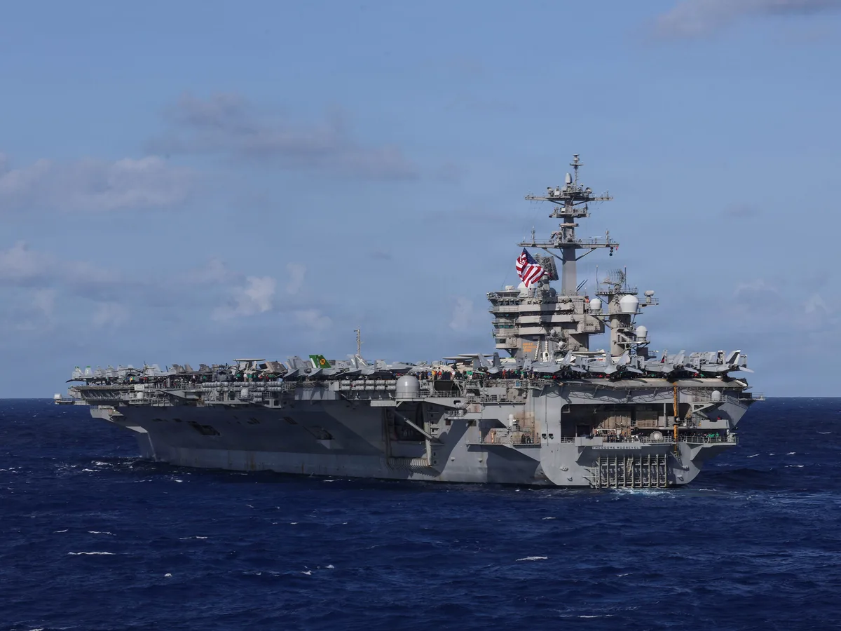 A US Navy carrier strike group just deployed with a big drone ship for the first time