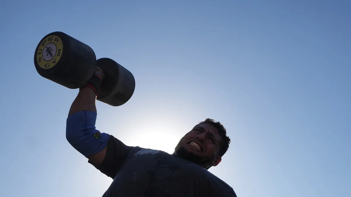 Burly men in Gaza pull trucks and flip tires in competition of strength