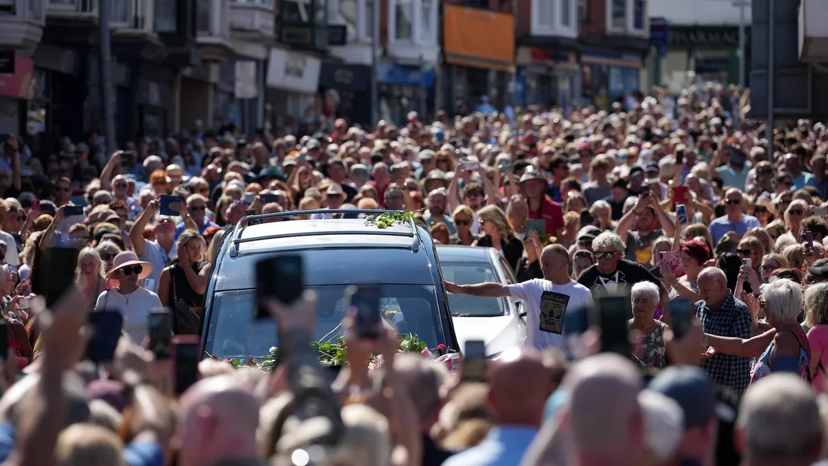 Bonnie Tyler fans line the streets of a Welsh village as her coffin is brought home