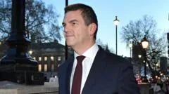 Ex-top official Robbins reaches settlement with government over sacking