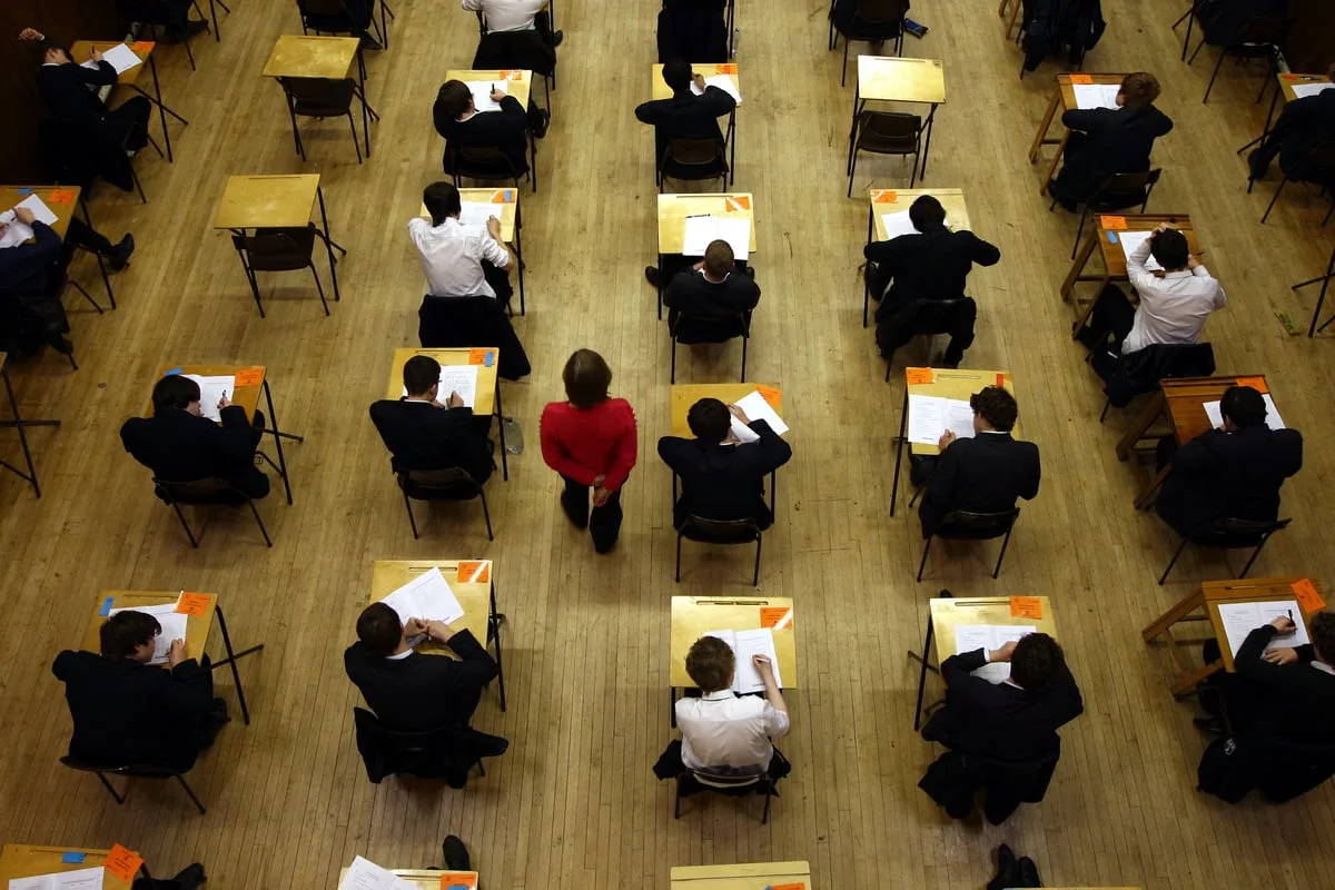 Top GCSE grades rise but key pass rate returns to pre-pandemic levels