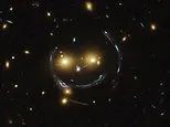 Say cheese! NASA reveals stunning image of giant 'cosmic smile' created by warped spacetime