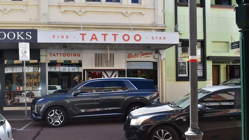 Local tattoo shop bracing for long night as Dockers fans chase inaugural premiership ink